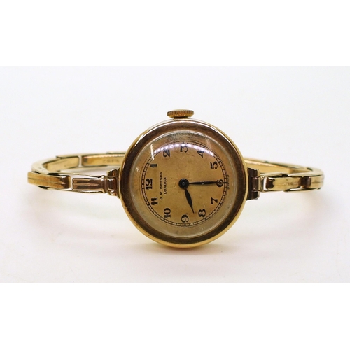 735 - An 18ct gold Bensons ladies watch head, London hallmarks for 1923, with a 9ct gold expanding strap m... 