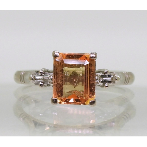 794 - An 18ct white gold baguette cut diamond and peach coloured sapphire ring, finger size N, weight 4.2g... 