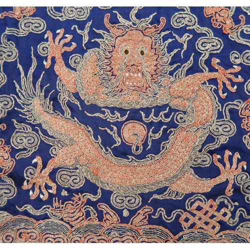 2470A - A CHINESE SILK EMBROIDERED RANK BADGEin gilt weave, depicting a five clawed dragon chasing amongst c... 