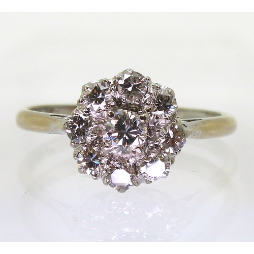 2777 - A DIAMOND FLOWER RINGthe classic galleried mount is set with estimated approx 0.80cts of brilliant c... 