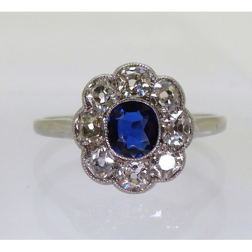 2782 - A SAPPHIRE & DIAMOND RINGin the classic flower formation, with a handmade white metal galleried ... 