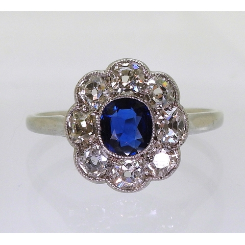 2782 - A SAPPHIRE & DIAMOND RINGin the classic flower formation, with a handmade white metal galleried ... 