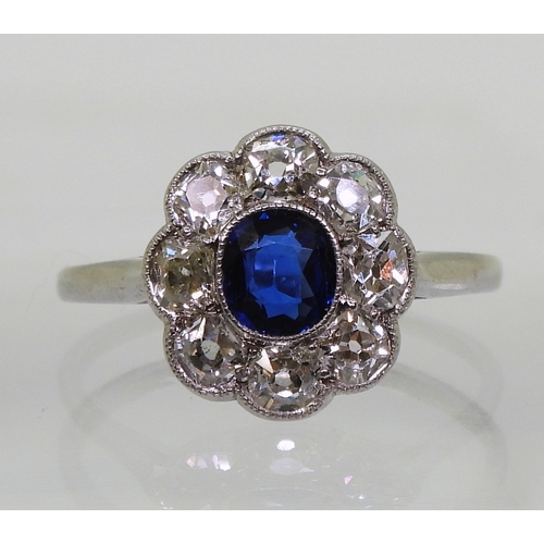 2782 - A SAPPHIRE & DIAMOND RINGin the classic flower formation, with a handmade white metal galleried ... 