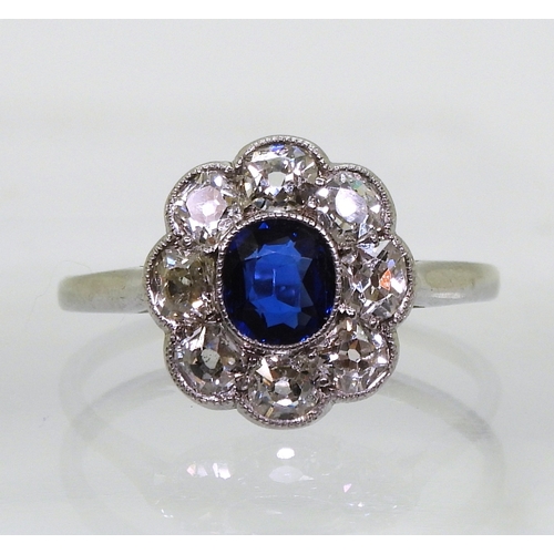 2782 - A SAPPHIRE & DIAMOND RINGin the classic flower formation, with a handmade white metal galleried ... 