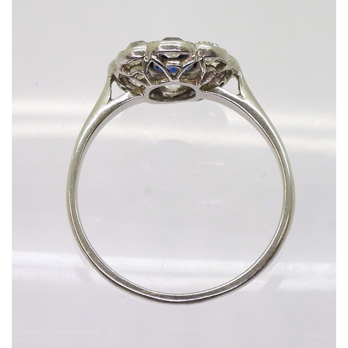 2782 - A SAPPHIRE & DIAMOND RINGin the classic flower formation, with a handmade white metal galleried ... 