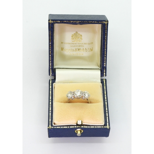 2783 - A SUBSTANTIAL THREE STONEdiamond ring. The classic galleried mount is in 18ct white gold, and set wi... 