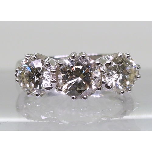 2783 - A SUBSTANTIAL THREE STONEdiamond ring. The classic galleried mount is in 18ct white gold, and set wi... 