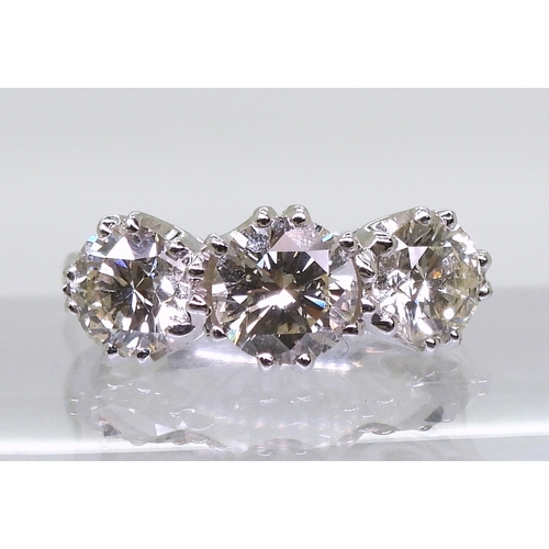 2783 - A SUBSTANTIAL THREE STONEdiamond ring. The classic galleried mount is in 18ct white gold, and set wi... 