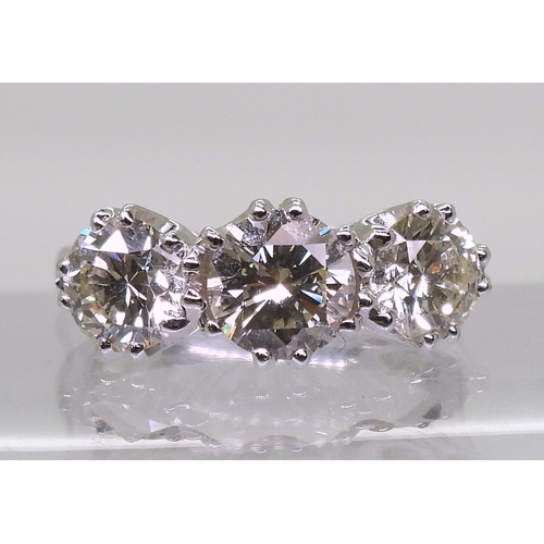 2783 - A SUBSTANTIAL THREE STONEdiamond ring. The classic galleried mount is in 18ct white gold, and set wi... 