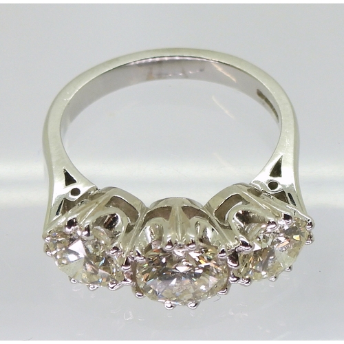 2783 - A SUBSTANTIAL THREE STONEdiamond ring. The classic galleried mount is in 18ct white gold, and set wi... 