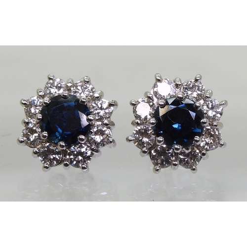 2785 - SAPPHIRE & DIAMOND EARRINGSthe classic flower clusters are set with a 5.5mm round cut sapphire a... 