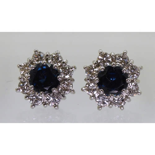 2785 - SAPPHIRE & DIAMOND EARRINGSthe classic flower clusters are set with a 5.5mm round cut sapphire a... 