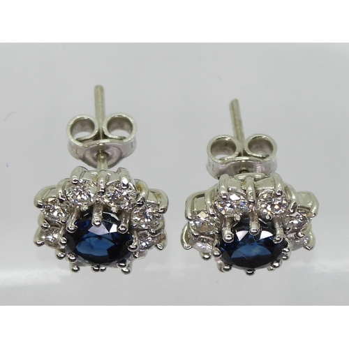 2785 - SAPPHIRE & DIAMOND EARRINGSthe classic flower clusters are set with a 5.5mm round cut sapphire a... 