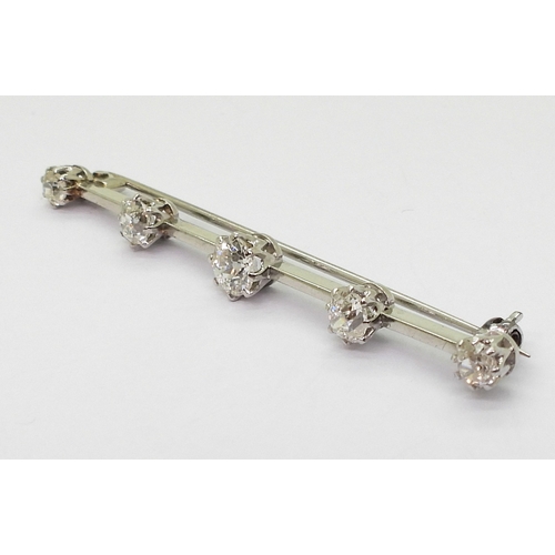 2788 - A FIVE STONE DIAMOND BAR BROOCHset with five old cut diamonds with an estimated approx diamond total... 