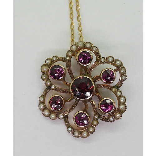 2790 - AN EDWARDIAN PENDANTmade in 9ct gold and set with garnets and pearls to the classic flower shape, di... 