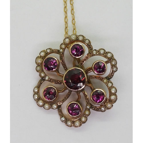 2790 - AN EDWARDIAN PENDANTmade in 9ct gold and set with garnets and pearls to the classic flower shape, di... 