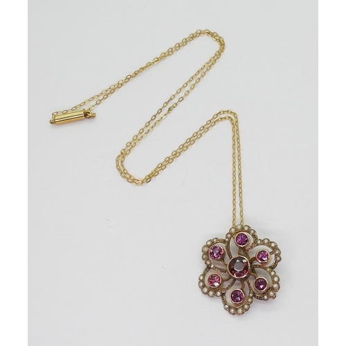 2790 - AN EDWARDIAN PENDANTmade in 9ct gold and set with garnets and pearls to the classic flower shape, di... 