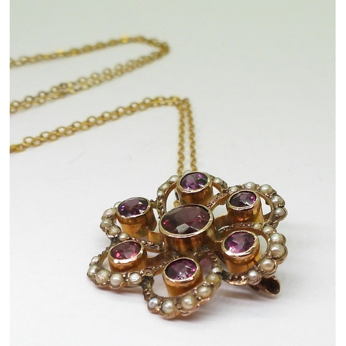 2790 - AN EDWARDIAN PENDANTmade in 9ct gold and set with garnets and pearls to the classic flower shape, di... 