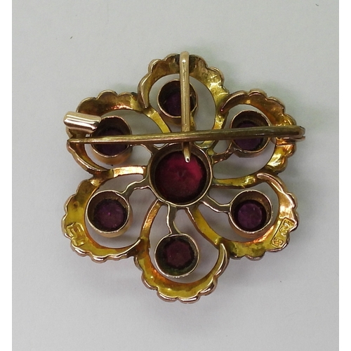 2790 - AN EDWARDIAN PENDANTmade in 9ct gold and set with garnets and pearls to the classic flower shape, di... 