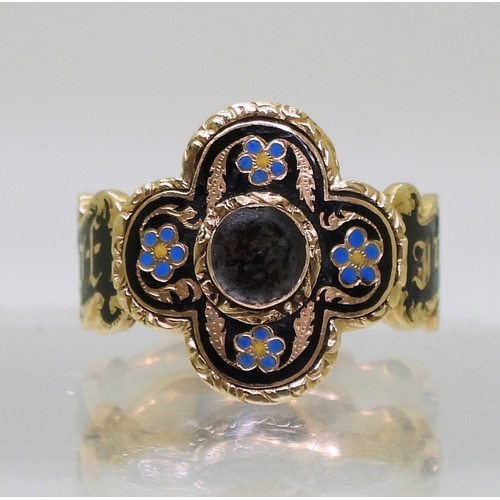 2798 - AN UNUSUAL MOURNING RINGwith bright yellow metal four lobed design. To the front with forget-me not ... 