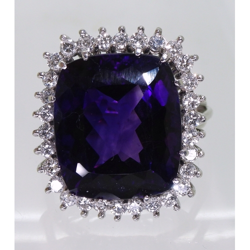 2801 - AMETHYST & DIAMOND RINGset in 18k white gold classic basket mount with a large cushion cut ameth... 