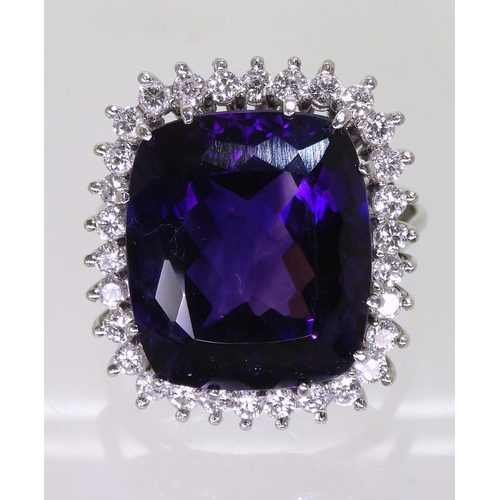 2801 - AMETHYST & DIAMOND RINGset in 18k white gold classic basket mount with a large cushion cut ameth... 