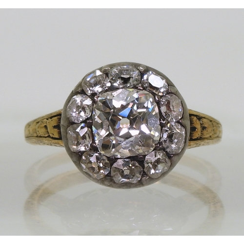 2802 - AN ANTIQUE DIAMOND RINGset with a cushion cut diamond of estimated approx 1.30cts surrounded with te... 