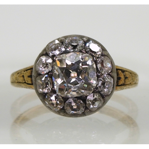 2802 - AN ANTIQUE DIAMOND RINGset with a cushion cut diamond of estimated approx 1.30cts surrounded with te... 