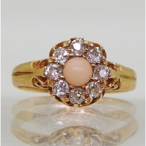 2803 - CORAL & DIAMOND RINGan 18ct gold scrolled mount set with a coral cabochon surrounded with old cu... 