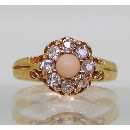 2803 - CORAL & DIAMOND RINGan 18ct gold scrolled mount set with a coral cabochon surrounded with old cu... 