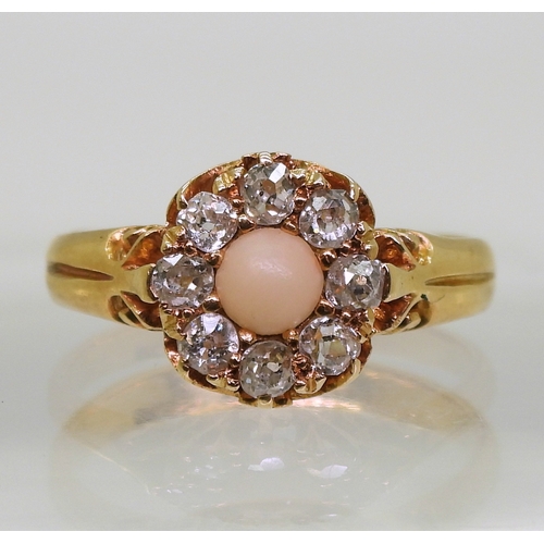 2803 - CORAL & DIAMOND RINGan 18ct gold scrolled mount set with a coral cabochon surrounded with old cu... 