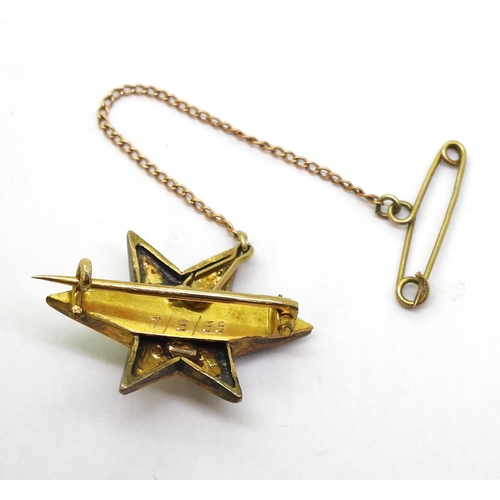 2805 - A STAR BROOCHthe bright yellow metal six pointed star brooch is set with a  central old cut dia... 