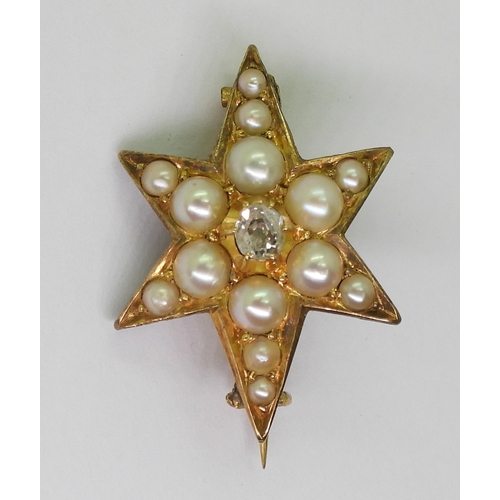 2805 - A STAR BROOCHthe bright yellow metal six pointed star brooch is set with a  central old cut dia... 