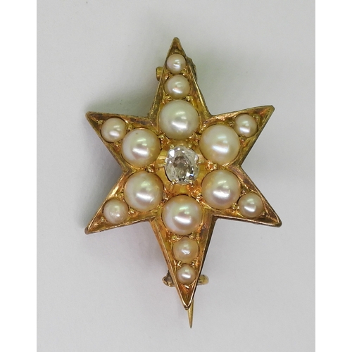 2805 - A STAR BROOCHthe bright yellow metal six pointed star brooch is set with a  central old cut dia... 