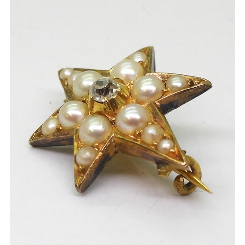 2805 - A STAR BROOCHthe bright yellow metal six pointed star brooch is set with a  central old cut dia... 