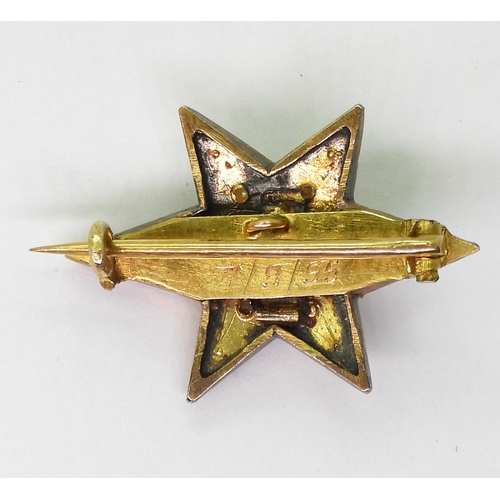 2805 - A STAR BROOCHthe bright yellow metal six pointed star brooch is set with a  central old cut dia... 