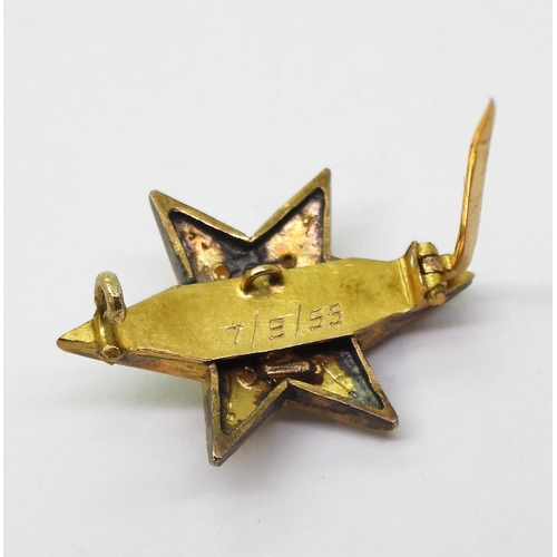 2805 - A STAR BROOCHthe bright yellow metal six pointed star brooch is set with a  central old cut dia... 