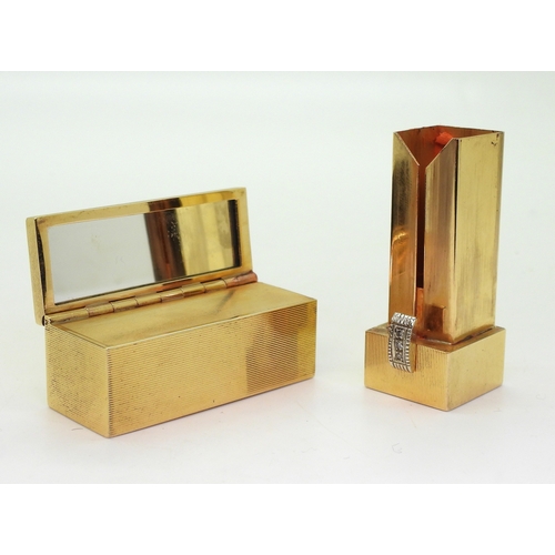 2810 - A DECORATIVE LIPSTICK COMPACTmade in 18k (stamped 750,) gold with all over engine turned linear engr... 