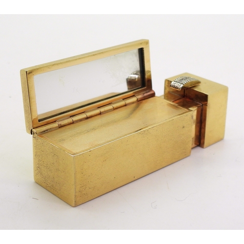 2810 - A DECORATIVE LIPSTICK COMPACTmade in 18k (stamped 750,) gold with all over engine turned linear engr... 