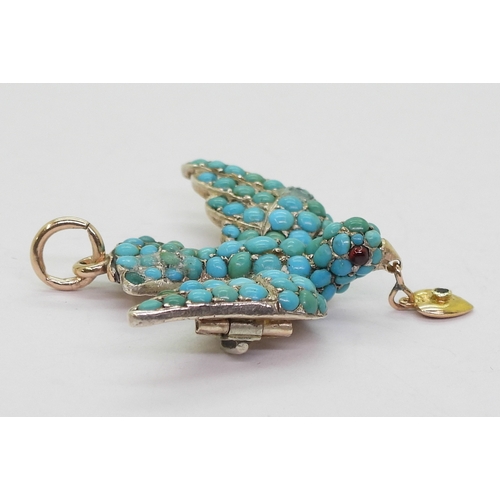 2817 - A TURQUOISE BIRD PENDANTthe yellow and white metal mount is set throughout with turquoise, with red ... 