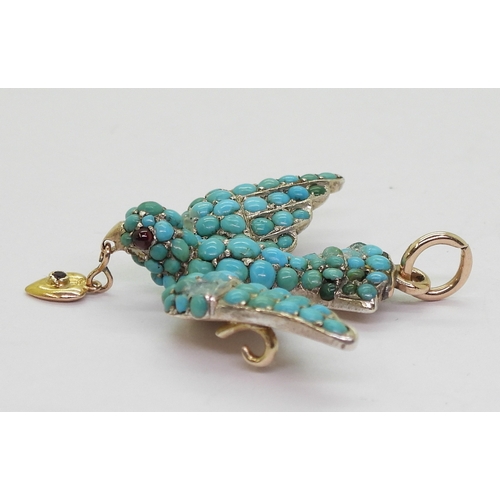 2817 - A TURQUOISE BIRD PENDANTthe yellow and white metal mount is set throughout with turquoise, with red ... 