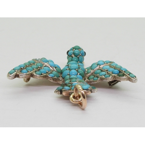 2817 - A TURQUOISE BIRD PENDANTthe yellow and white metal mount is set throughout with turquoise, with red ... 