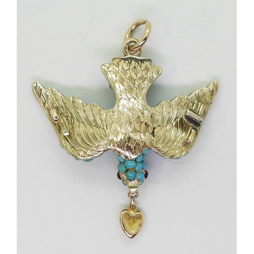 2817 - A TURQUOISE BIRD PENDANTthe yellow and white metal mount is set throughout with turquoise, with red ... 