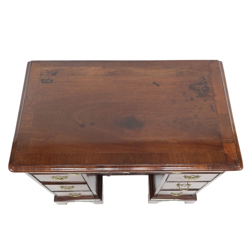 2059 - A GEORGE II WALNUT LADIES KNEEHOLE DESKwith rectangular crossbanded top over two long drawers over t... 