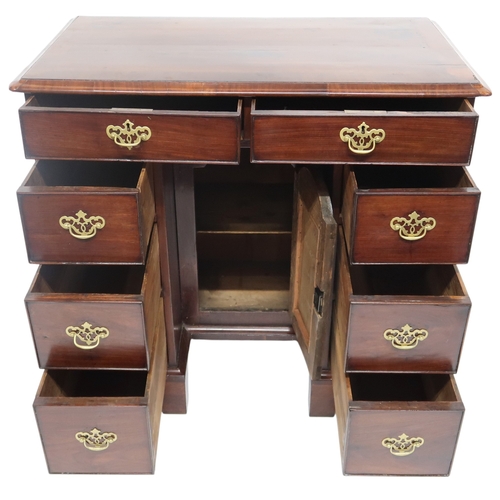 2059 - A GEORGE II WALNUT LADIES KNEEHOLE DESKwith rectangular crossbanded top over two long drawers over t... 