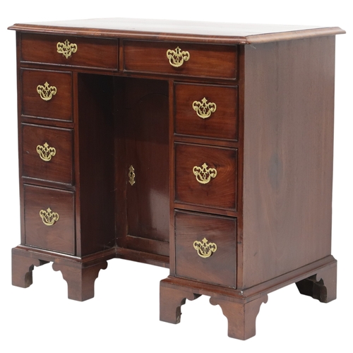 2059 - A GEORGE II WALNUT LADIES KNEEHOLE DESKwith rectangular crossbanded top over two long drawers over t... 