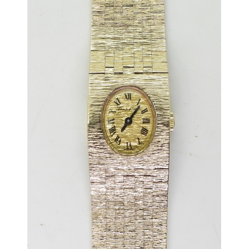 2894 - A 9CT BUECHE GIRODladies watch with retro integral bark textured strap, hallmarked London 1972, gold... 