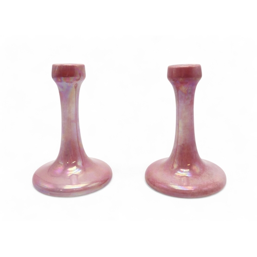 2288 - A PAIR OF 1920'S RUSKIN CANDLESTICKSin pink lustre glaze, impressed marks and date, 17cm high (2)... 