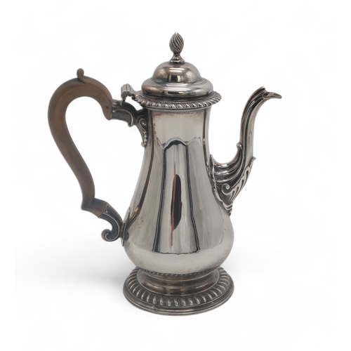 2501A - A GEORGE III SILVER COFFEE POTby William Grundy, London 1772, of plain baluster form, with a rococo ... 