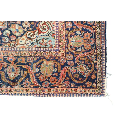 2160 - A RED GROUND FINE PILE ISFAHAN RUG with dark blue and cream central medallion and matching span... 